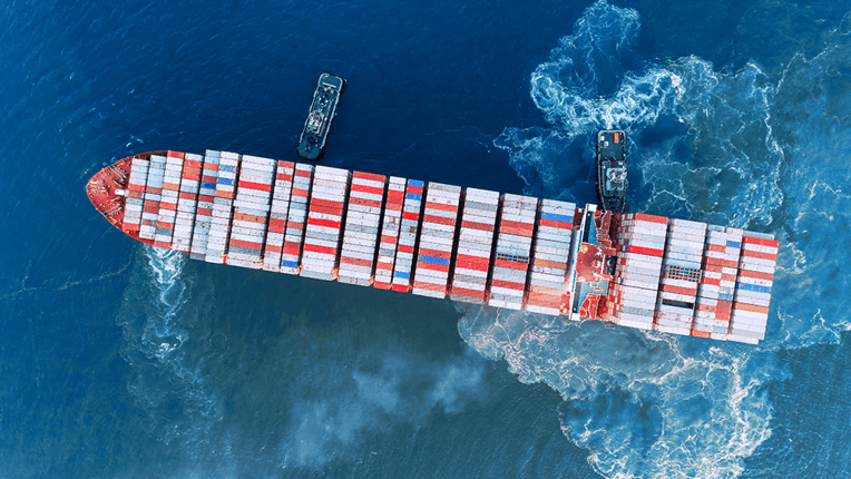 Aerial top view Tug boat drag container ship to sea port for unloading container at crane bridge for import export, shipping or transportation