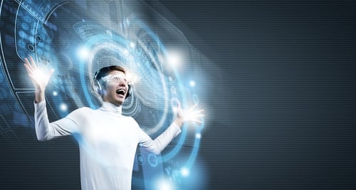 Young man wearing futuristic glasses against blue background