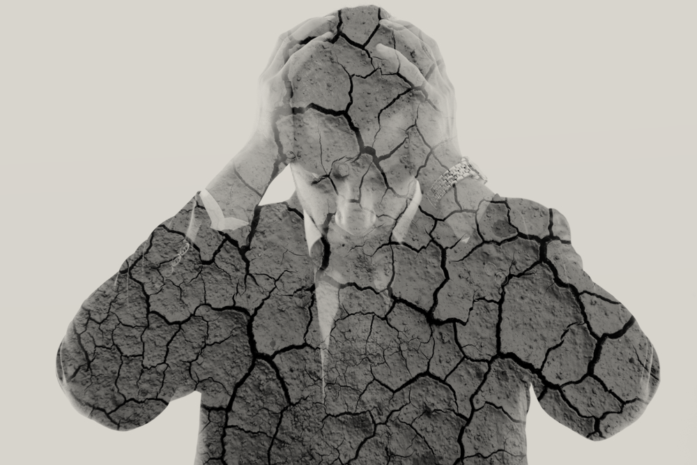 double exposure of depressed business man and dry ground background green